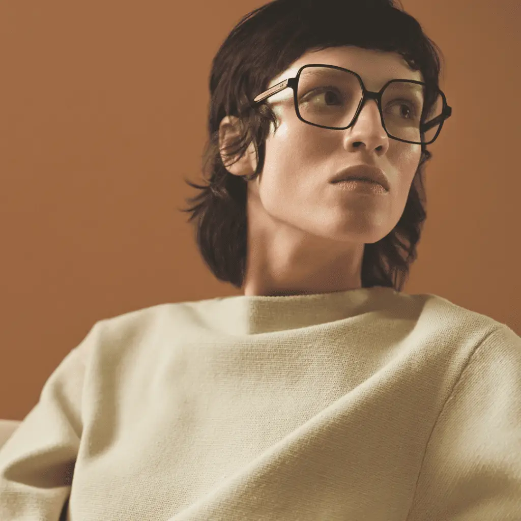 Frau mit Götti-Brille und beigem Oberteil